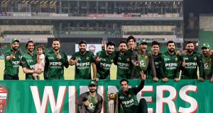 Pakistani players pose with the trophy after winning the three-match T20 International series against Bangladesh at Gaddafi Stadium in Lahore on Sunday, June 1, 2025.