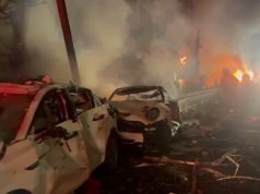 Footage shows the immediate aftermath of an Iranian ballistic missile impact in central Israel, with emergency responders securing the area and assessing damage.