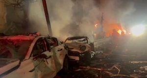 Footage shows the immediate aftermath of an Iranian ballistic missile impact in central Israel, with emergency responders securing the area and assessing damage.